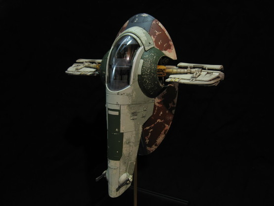 Scale model of Boba Fett's Slave One from Star Wars. With a dark background.
