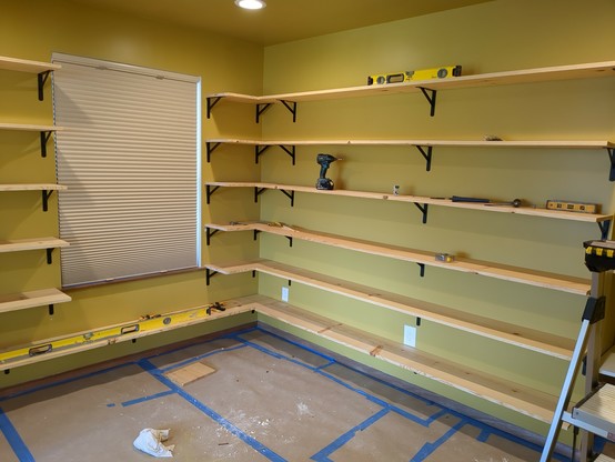 The next run of shelving wraps the corner and fills the next wall.