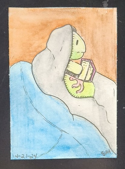 Tattooed turtle wrapped up in a blanket reading on a cozy day.