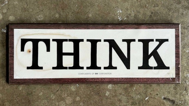 Tame the creative mind! Photograph of a 1960s IBM Corporation wooden wall sign laminated plaque with the word "THINK" in large letters and the phrase "COMPLIMENTS OF IBM CORPORATION" in small letters underneath.
