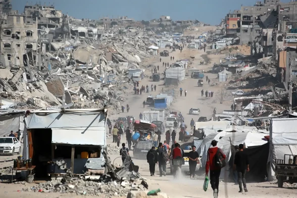 Palestinians carry their belongings as they are forced to flee Gaza City.