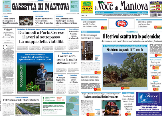 Una schermata di un tablet mostra due pagine di giornali affiancate. A sinistra c'è la "Gazzetta di Mantova" e a destra "La Voce di Mantova". Entrambi i giornali presentano articoli e immagini. La "Gazzetta di Mantova" ha un titolo principale che parla di lavori a Porta Cerese e un altro articolo che menziona un'iniziativa di Food4Science. "La Voce di Mantova" ha un titolo principale riguardante un festival e un'immagine di un albero. Entrambi i giornali contengono vari articoli e annunci pubblicitari.
