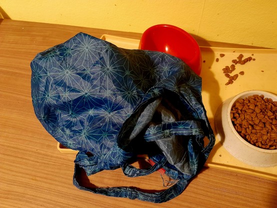 A blue cloth bag has been draped for the remains of Pussy's breakfast.