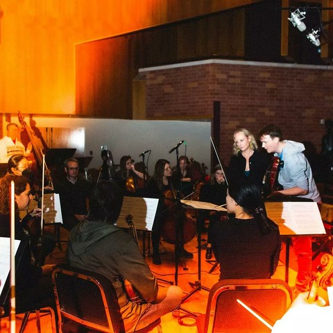 Cover of Patrick Conlon & Christina Giacona's Onyx Lane Records album "In the Waiting Room: 4 Works for String Orchestra", featuring the composers consulting the score during a rehearsal.