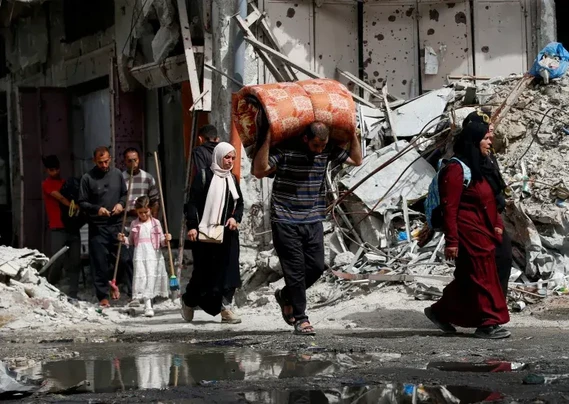 Palestinians flee their homes after Israeli air strikes in the northern Gaza Strip May 17, 2025 [Mahmoud Issa/ Reuters]