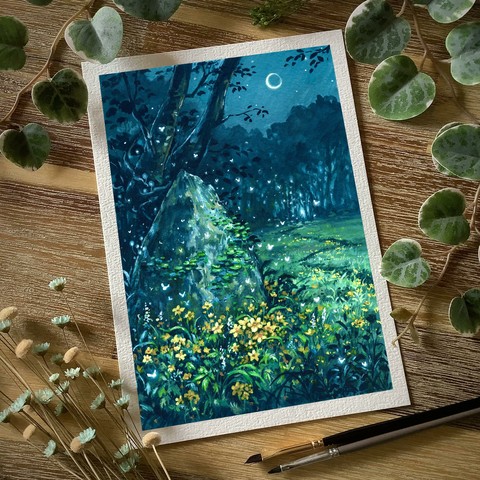 A photo of a portrait-format painting placed on a wooden table and surrounded by paint brushes, dried flowers, and leaves for decoration. The painting features a pointy standing stone surrounded by dense yellow flower clusters, a thin pathway leading towards a softly glowing treeline through a grassy meadow. Tiny glowing fairies flit from the stone to the treeline. A sickle moon hovers above in the nightsky.