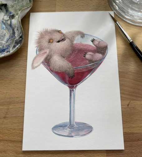 a painting of a little furry monster lying in a martini glass which appears to also have a cosmopolitan cocktail in it.