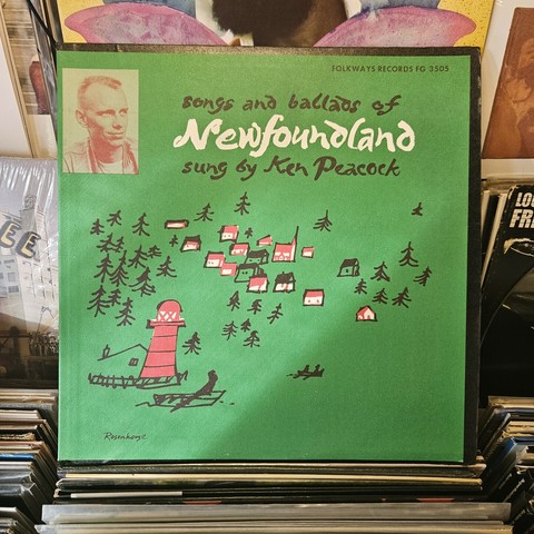 Green album cover features drawing of houses among trees, and a red lighthouse on a shore. In the corner is a small photograph of Ken Peacock, sporting a short crew cut.