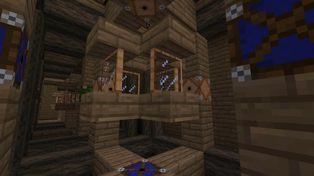 Strange wooden structure featuring blue laser emitters (turned off), glass panes, and laser detectors, all inset in a larger cubic wooden frame.