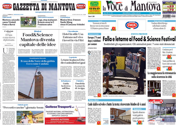 Due prime pagine di giornali locali. A sinistra, la "Gazzetta di Mantova" con il titolo principale "Food&Science: Mantova diventa capitale delle idee". A destra, "La Voce di Mantova" con il titolo principale "Folla e letame al Food & Science Festival". Entrambi i giornali presentano vari articoli e immagini, tra cui una torre e una scena di strada. Ci sono anche annunci pubblicitari nella parte inferiore delle pagine.  .