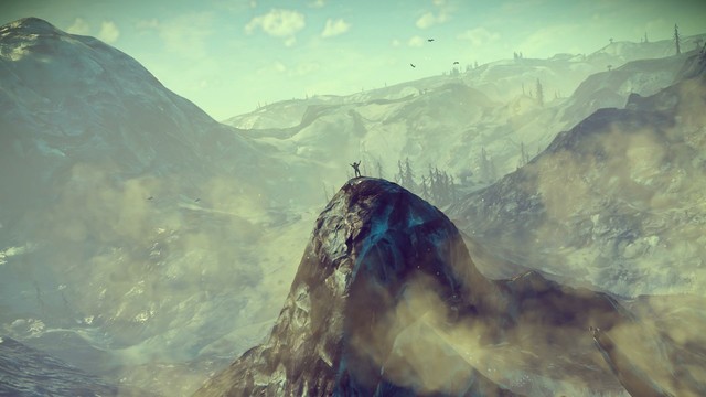 Character atop a mountain peak in the game No Man's Sky
