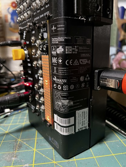 A certification label from the packaging of some computer peripheral, used to cover the empty 2HP, but then wrapping around the side of the case.