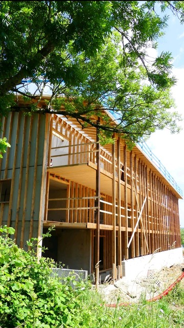Timber straw earth house in the making. (With concrete foundation)