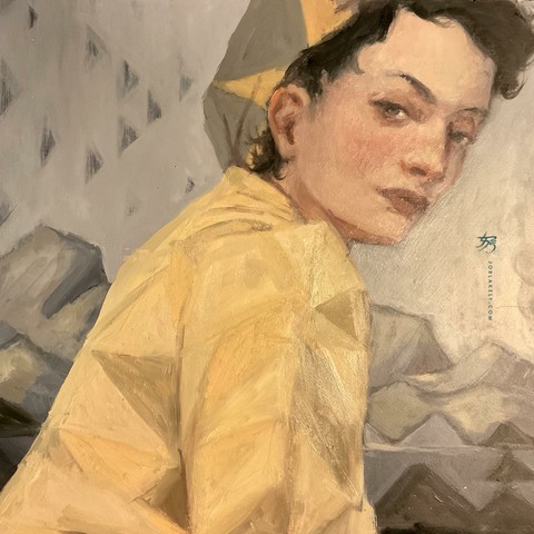 A woman with dark short hair under a hat in grey with golden yellow triangular crown-like ray shapes. She wears a golden emergency blanket emphasizing the trianglular shapes from the folds. She sits in profile, head turned back looking at viewer. Mountains are behind her in neutral grey tones, warm & cool, also emphasizing these shapes as light hits the mountain sides. Some solid black triangles in foreground standing in as rock and tree. 
In the sky faded out is a flying geese quilt pattern in a loose migration formation.
