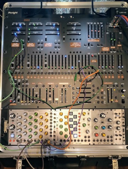 Behringer Arp 2600 semi modular clone (black model) in a mixer case, along with a row of Behringer Arp 2500 modules for sequencing, mixing, amplifying, filtering. 5 independent CV sequences can fully control the 2600