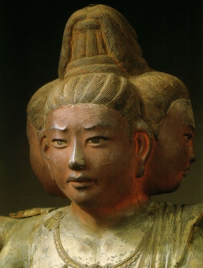 a close-up of one of the faces, the faces are light red