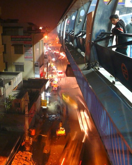Photo of a metro platform in India overlooking a busy neighborhood with blurred vehicles in motion below.

Colin Hughes (CC BY-NC-ND 2.0)
https://flic.kr/p/bdV7w2