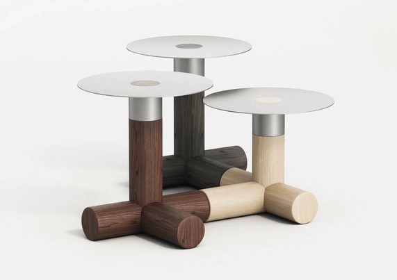 Three interlocked modern modular side tables with circular tops and cylindrical wooden bases in varying shades of brown and cream, featuring metal accents.