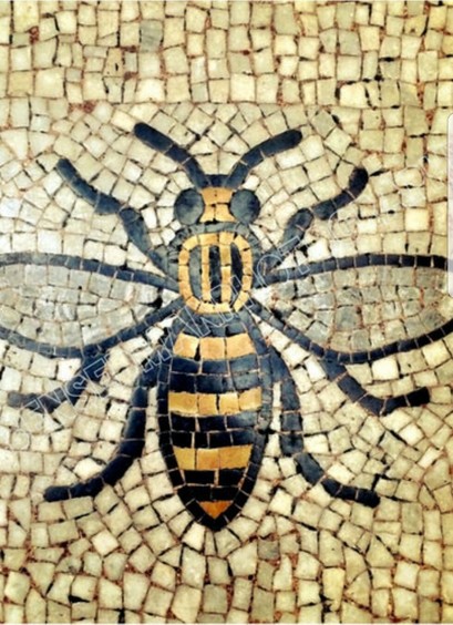 Image of a mosaic design. A black and yellow Bumblebee made with tiles, is surrounded by light brown and off-white tiles.