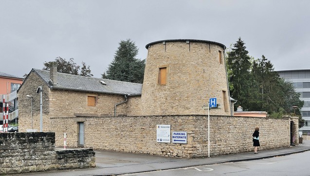 Image of the threatened windmill in val fleuri, before construction works started. the actual windmill part of it is missing due to it being previously destroyed in a fire, only the bottom part made from stone, the building attached to it and walls surrounding it still stand.

Image sourced from Wikimedia commons under cc attribution 3 Luxembourg_City_Val_Fleuri_windmill_ruins.jpg

https://commons.wikimedia.org/wiki/File:Luxembourg_City_Val_Fleuri_windmill_ruins.jpg