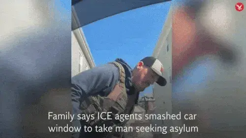 An animated GIF of a video clip of ICE agents smashing a family’s vehicle with an axe to drag the father out of the car.