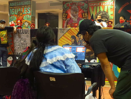 Armando Gómez (right, in black) works with other Otomí activists to record a meeting.