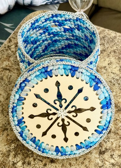 Hand Crocheted Circular box! Laser cut Snowflake wooden top and flat wooden bottom! Crocheted in Tshirt yarn for thickness and sturdy walls! Ideal to hold keys or any other odds and ends outa sight.