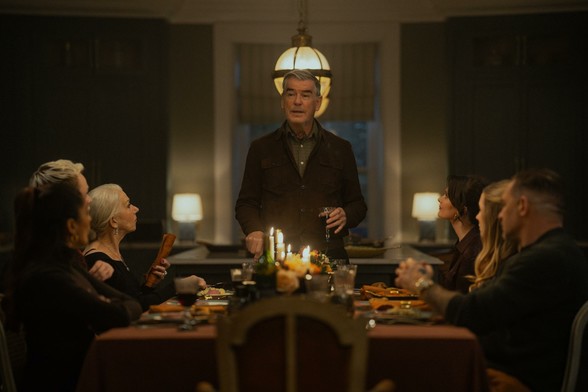 L-R Mandeep Dhillon as Seraphina Harrigan, Anson Boon as Eddie Harrigan, Helen Mirren as Maeve Harrigan, Pierce Brosnan as Conrad Harrigan, Emily Barber as Alice, Joanne Froggatt as Jan Da Souza and Tom Hardy as Harry Da Souza in MOBLAND, episode 9, season 1
