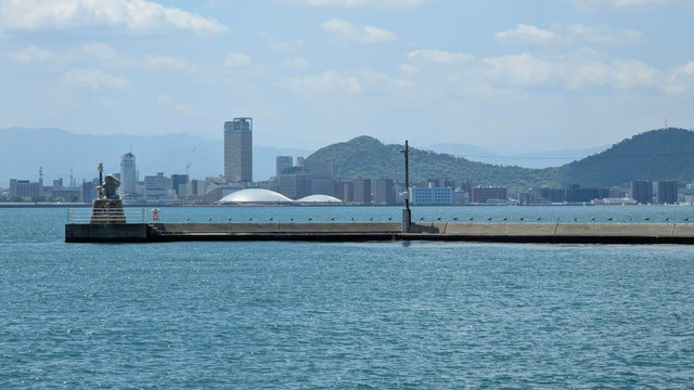 The Kagawa Arena seen from Megijima's port. There's also Takamatsu skyline as well as the Oni Lighthouse from Megijima.
