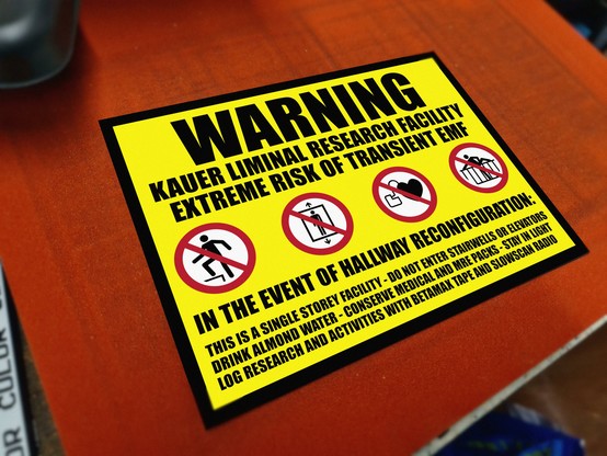 A backrooms themed sign warning of possible hallway reconfiguration