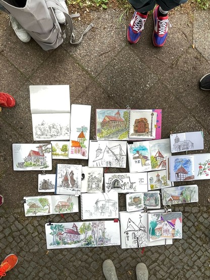 Several sketchbooks with sketches of the church are laying in the floor. It’s called the throwdown.