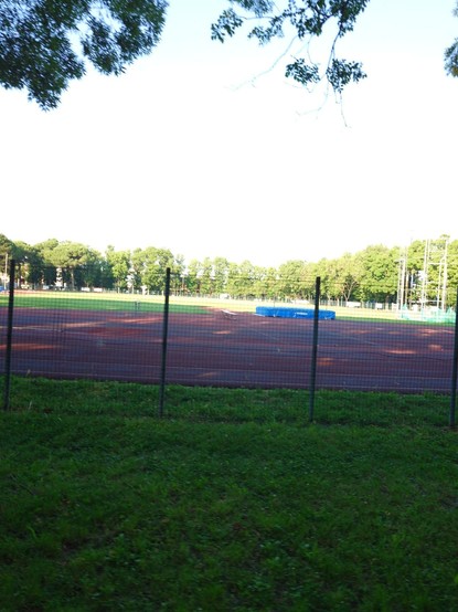 A track field and trees outside
Sunny weather