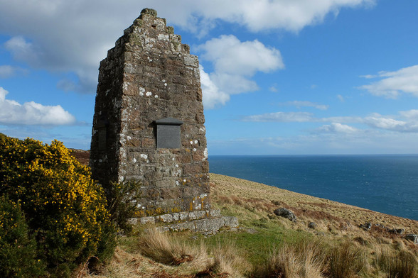 Badbea Clearances village memorial. A large pointed stone structure bearing plaques to commemorate the appalling hard lives of Scots dumped in inhospitable areas such as this clifftop site near Helmsdale.