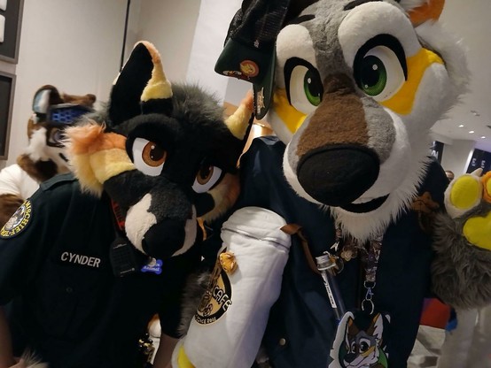 Two fursuiters looking directly into the camera.