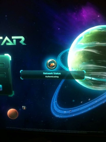 A screen displays a "Network Status: Authenticating" message with a circular, metallic-looking orange and yellow icon. The background is a vibrant space scene with a large, ringed greenish-blue planet on the right, a smaller reddish-orange planet on the lower left, and purple and blue nebulosity.