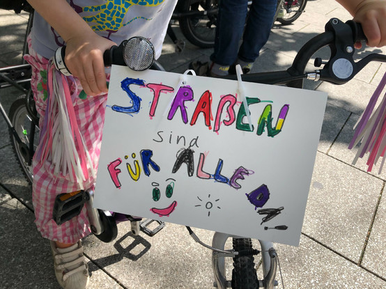 Kinderfahrrad mit Schild "Straßen sind für alle da!"
