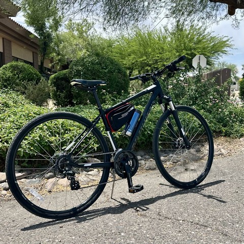 Specialized trail boss or whatever it’s called parked next to some bushes. BTW, that Little Rock Bros frame bag is perfect to carry your phone, a multi tool, some cash and , um, anything else you can think of.