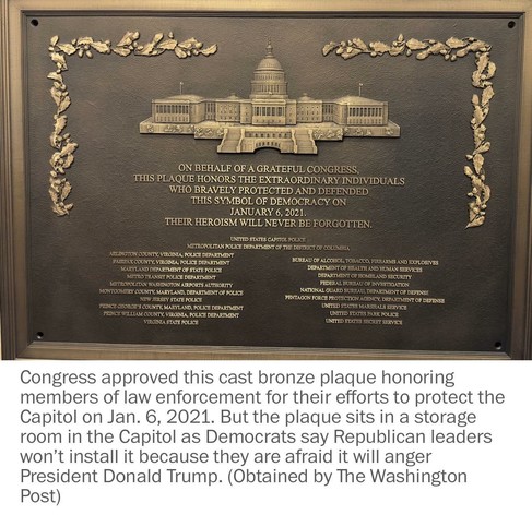 A cast bronze plaque honors law enforcement members for their bravery during the Capitol attack on January 6, 2021. It features a depiction of the Capitol building and lists various police departments. The plaque is currently stored instead of displayed due to political concerns…