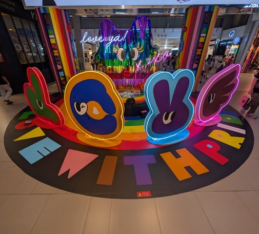 Colorful display of hands spelling out LOVE in sign language along with Love With Pride below it. Happy pride month. Captured with Google Pixel in Bangkok Thailand