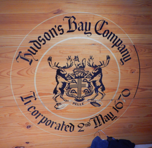 Hudson's Bay Company

Incorporated 2nd May 1670

Hudson's Bay's heraldic coat of arms—a symbol adorned with four beavers, two elks, a fox, and the Latin motto 'pro pelle cutem' (“a pelt for a skin”).

Insignia / Corporate seal of company on plywood adorning wall of store.

Photo by HiMY SYeD