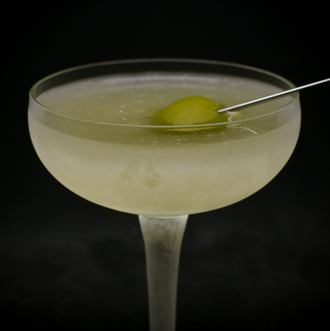 The cocktail itself in a chilled coupe and garnish with an olive