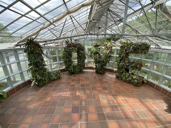A lush arrangement of succulents growing in ~4-foot tall letters that spell LOVE.