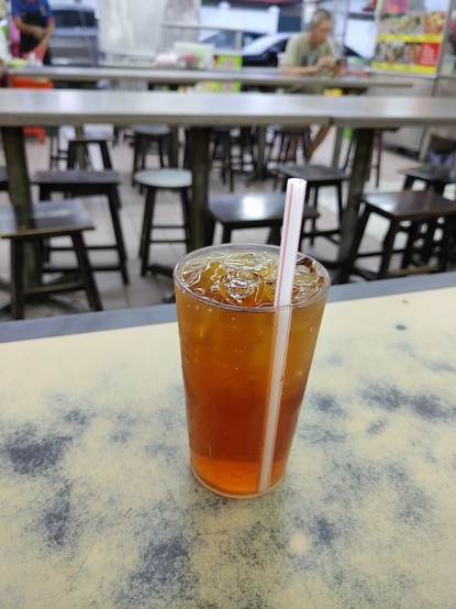 Teh o ais in an especially small cup, served at a kopitiam.