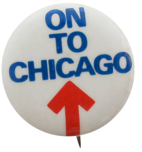 Designer Roger Black's button for the Chicago 1968 Democratic National Convention. The words “On to Chicago,” set like a headline in all blue capitals, dominates the top half of the button; the lower portion consists of a red arrow thrusting straight upward and pointing to the headline.