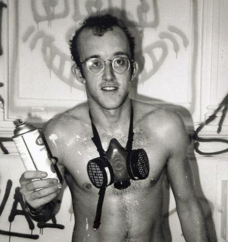 Keith Harring poses in a resperator holding a can of spray paint