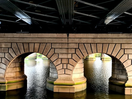 Granite arches supporting a Victorian railway bridge.
