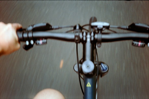 An attempt at a downward-looking view of my handlebars taken while riding