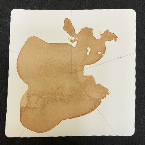The initial tile with a tea stain and five radiating spokes to help me draw the Podz string