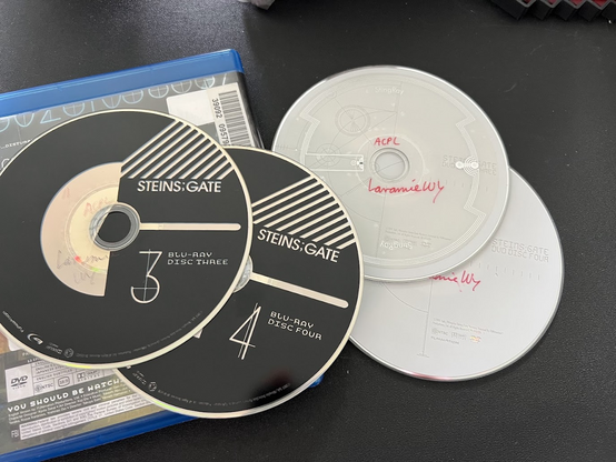 The contents of the Blu-ray Steins;Gate The Complete Series set I checked out from my library (via loan from another state library), consisting of DVD disc 3, DVD disc 4, Blu-ray disc 3, and Blu-ray disc 4.