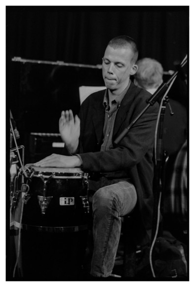 Black and white photograph of a percussionist playing drums.
